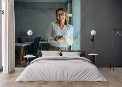 Cheerful businesswoman in office Wall mural