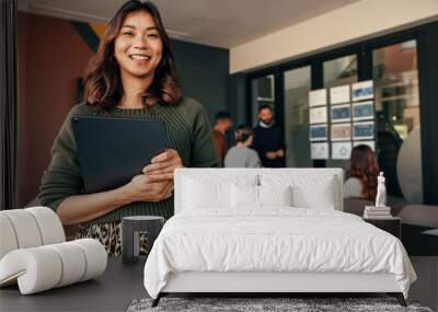 Cheerful businesswoman smiling at the camera in a boardroom Wall mural