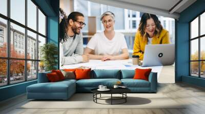 Cheerful design professionals having a meeting in an office Wall mural