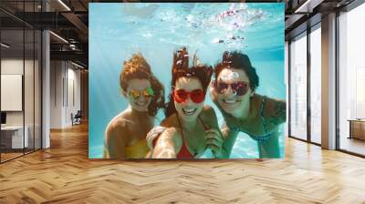 Cheerful friends making selfie underwater in pool Wall mural