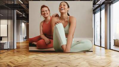 Cheerful women relaxing during a workout session Wall mural