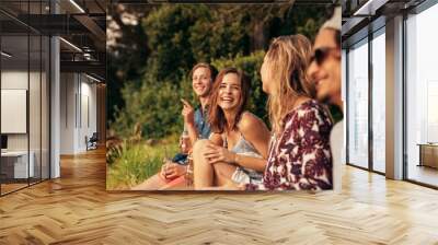 Cheerful young friends hanging out with beers Wall mural