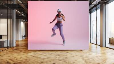 Cheerful young woman dancing in virtual reality Wall mural