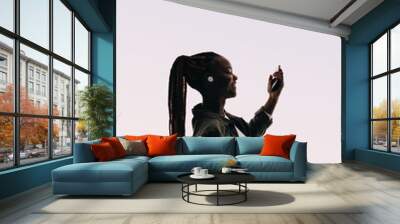 Cheerful young woman listening to music and dancing, enjoying a fun online playlist Wall mural