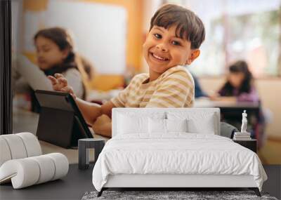 Child development in action as young kid learns to code with a tablet in school Wall mural