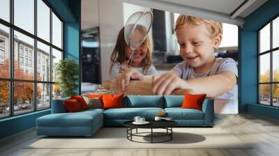 Children making cookies and having fun in the kitchen Wall mural