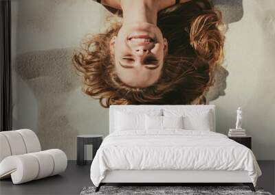 Close up of woman relaxing on beach sand Wall mural