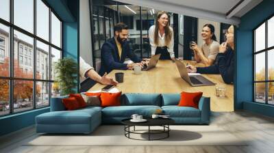 Colleagues laughing during a meeting Wall mural