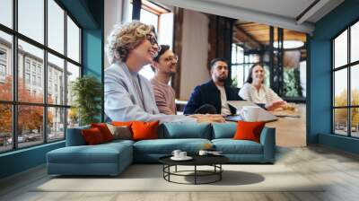 Conference meeting in an office, happy business team sits together in a boardroom Wall mural