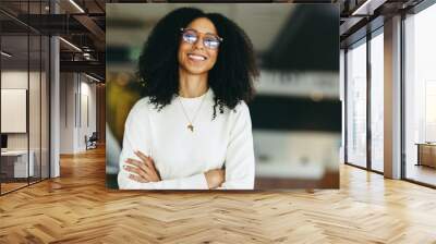 Confident young businesswoman smiling at the camera Wall mural