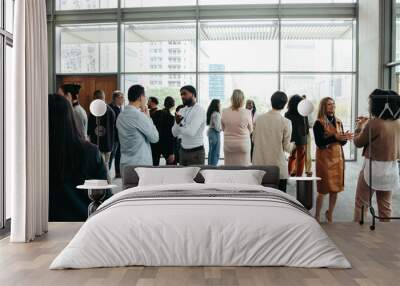 Corporate crowd engaging in teamwork during business event in modern office space Wall mural