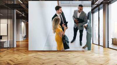 Corporate professionals having casual meeting in office lobby Wall mural