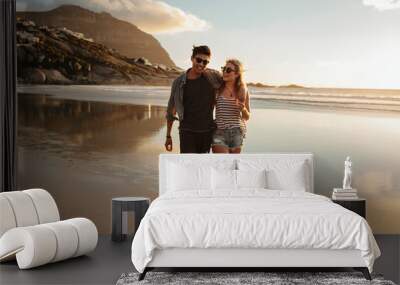 Couple enjoying a day at beach Wall mural