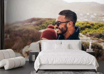 Couple enjoying a winter day at the beach Wall mural