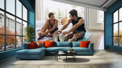 Couple exercising together at home Wall mural