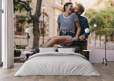 Couple having fun on a bicycle Wall mural