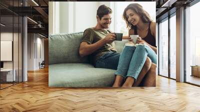 Couple relaxing at home with coffee Wall mural