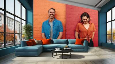 Couple standing by multicolored wall Wall mural