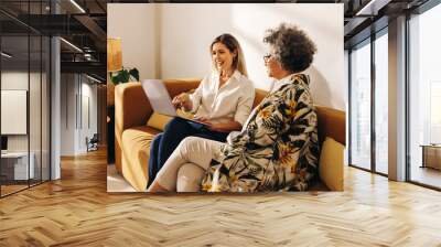 Creative businesswomen working together in an office lobby Wall mural