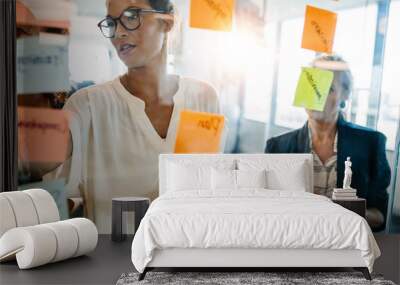 creative professionals looking over a post it note wall and disc Wall mural