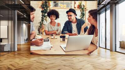 Creative team meeting in a coffee shop for business discussion Wall mural