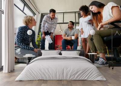 Creative team working on floor at work space Wall mural