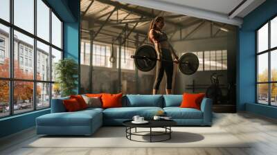 Cross fit woman lifting heavy weights in gym Wall mural