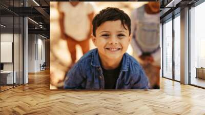 Cute boy smiling with friends Wall mural