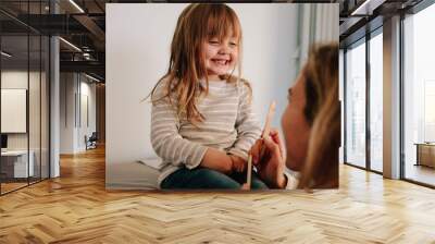 Cute girl visiting pediatrician for treatment Wall mural