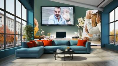 Diverse businesspeople having a video conference in a boardroom Wall mural