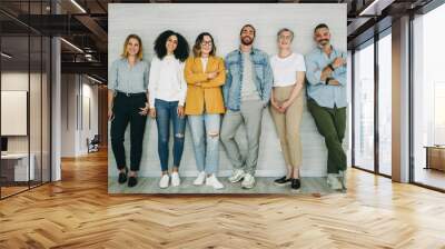 Diverse businesspeople standing together against a wall Wall mural