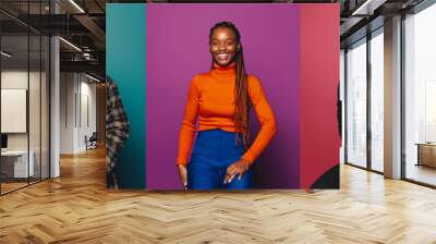 Diverse group of joyful people posing in vibrant studio settings Wall mural