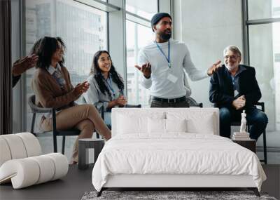 Diverse group of people engaged in a lively business meeting discussion Wall mural