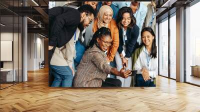 Diverse group of professionals taking a cheerful selfie together during a casual team meeting Wall mural