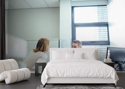 Doctor explaining diagnosis to female patient Wall mural