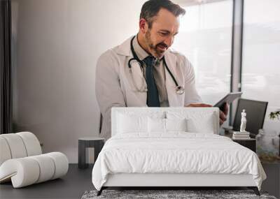 Doctor using digital tablet at his clinic Wall mural