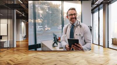 Doctor with digital tablet in his office Wall mural