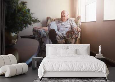 Elderly man sitting on arm chair at old age home Wall mural