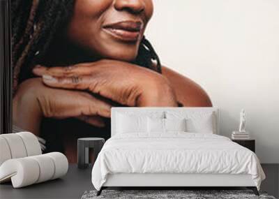 Elegant woman with dreadlocks wearing a bath towel against a studio background Wall mural