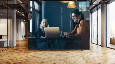 Executive sharing proposal on laptop with colleagues Wall mural