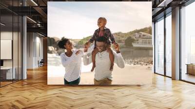 Family having fun on beach vacation Wall mural