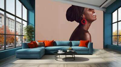 Fashionable african woman smiling on beige background Wall mural