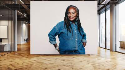 Fashionable mature woman looking at the camera in a studio Wall mural