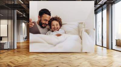 Father and son having fun at home Wall mural