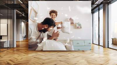 Father and son having fun playing at home Wall mural