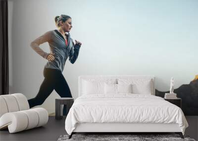 Female athlete jogging Wall mural