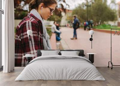 Female college student using laptop at campus Wall mural