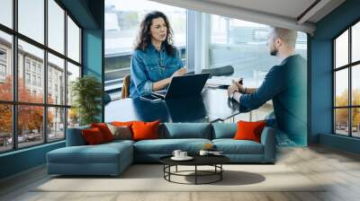 Female employer taking interview of a job applicant Wall mural