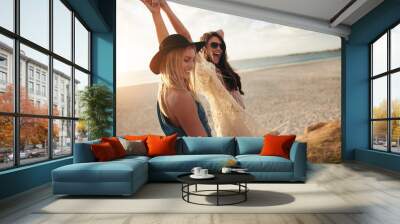 Female friends enjoying a day at sea coast Wall mural