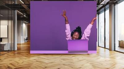 Female gamer celebrating winning an online video game Wall mural